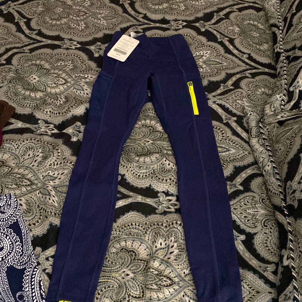 Super cute blue leggings with green zippers.